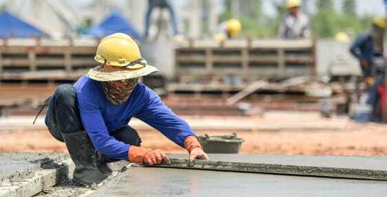Concrete Pool Deck Leveling This image shows a man resurfacing a cement floor.