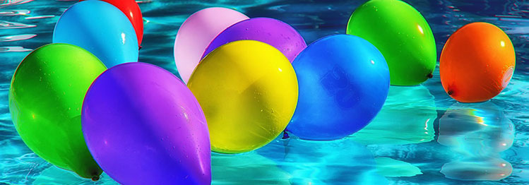 This image shows colorful balloons on a pool.
