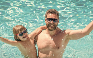 This image shows a man and a child enjoying the pool.